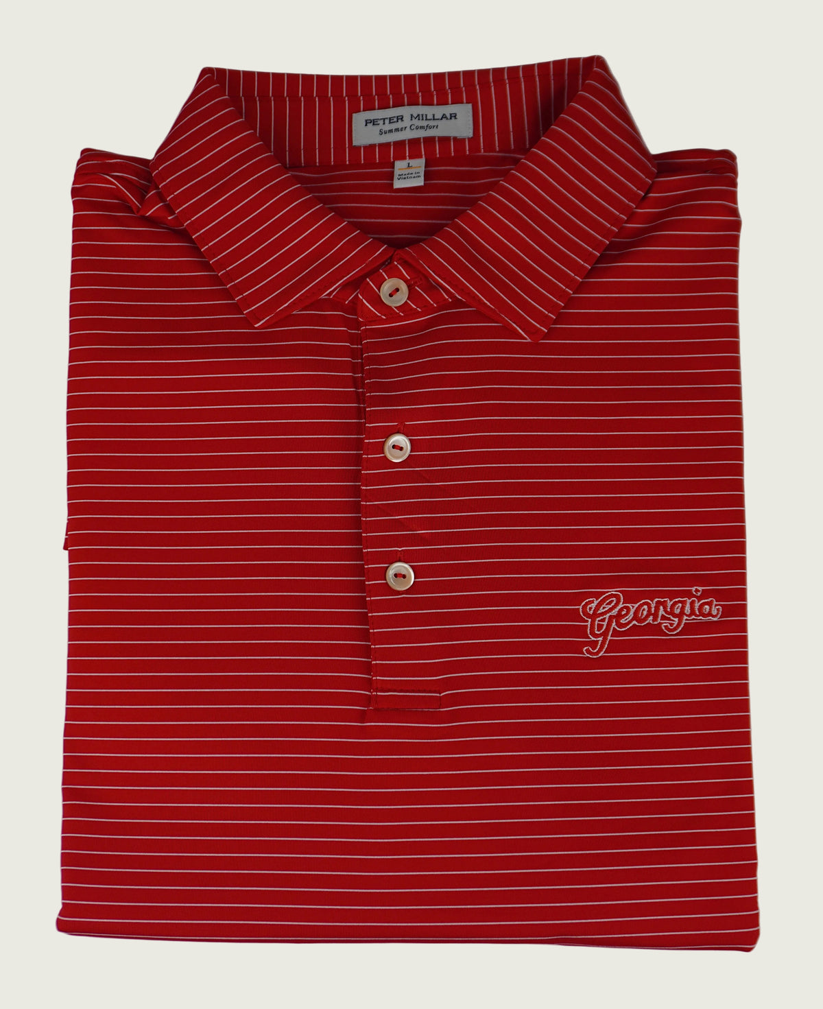 Folded red striped polo shirt with 'Georgia' logo on a white background