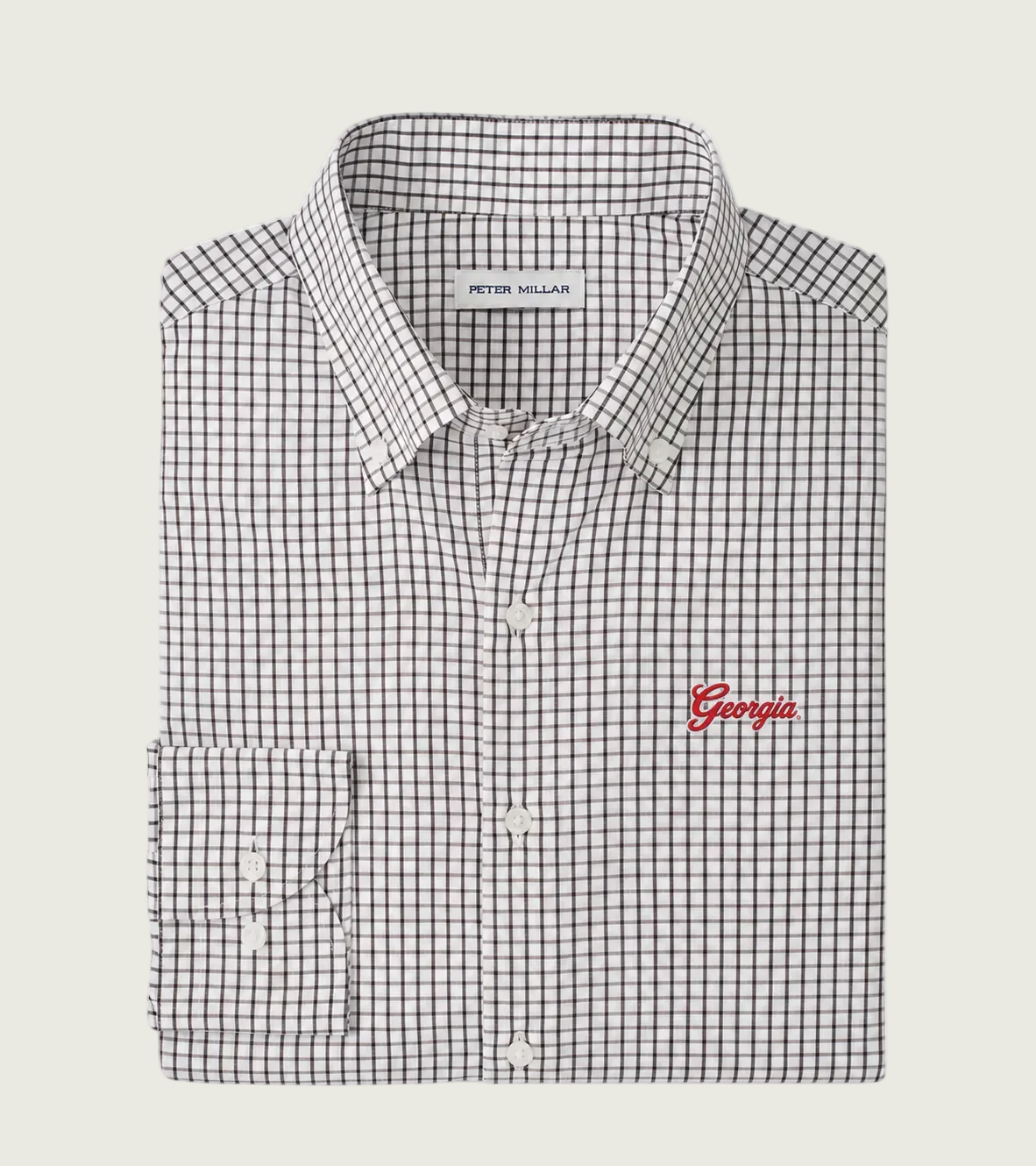 A Peter Millar long-sleeve dress shirt with a black and white micro-check pattern and a red embroidered 'Georgia' logo on the chest, displayed flat against a light gray background.