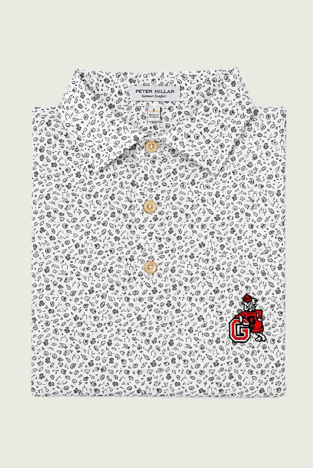 A folded Peter Millar Tulum Collection short-sleeve shirt with a white base, black and gray paisley pattern, and a red embroidered mascot logo on the lower right front.