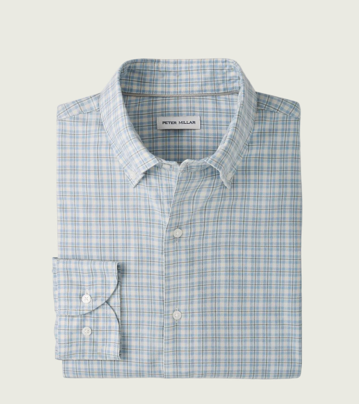 A folded Peter Millar dress shirt with a light blue and white windowpane plaid pattern, featuring a classic collar, button-down front, and a single-button folded cuff.