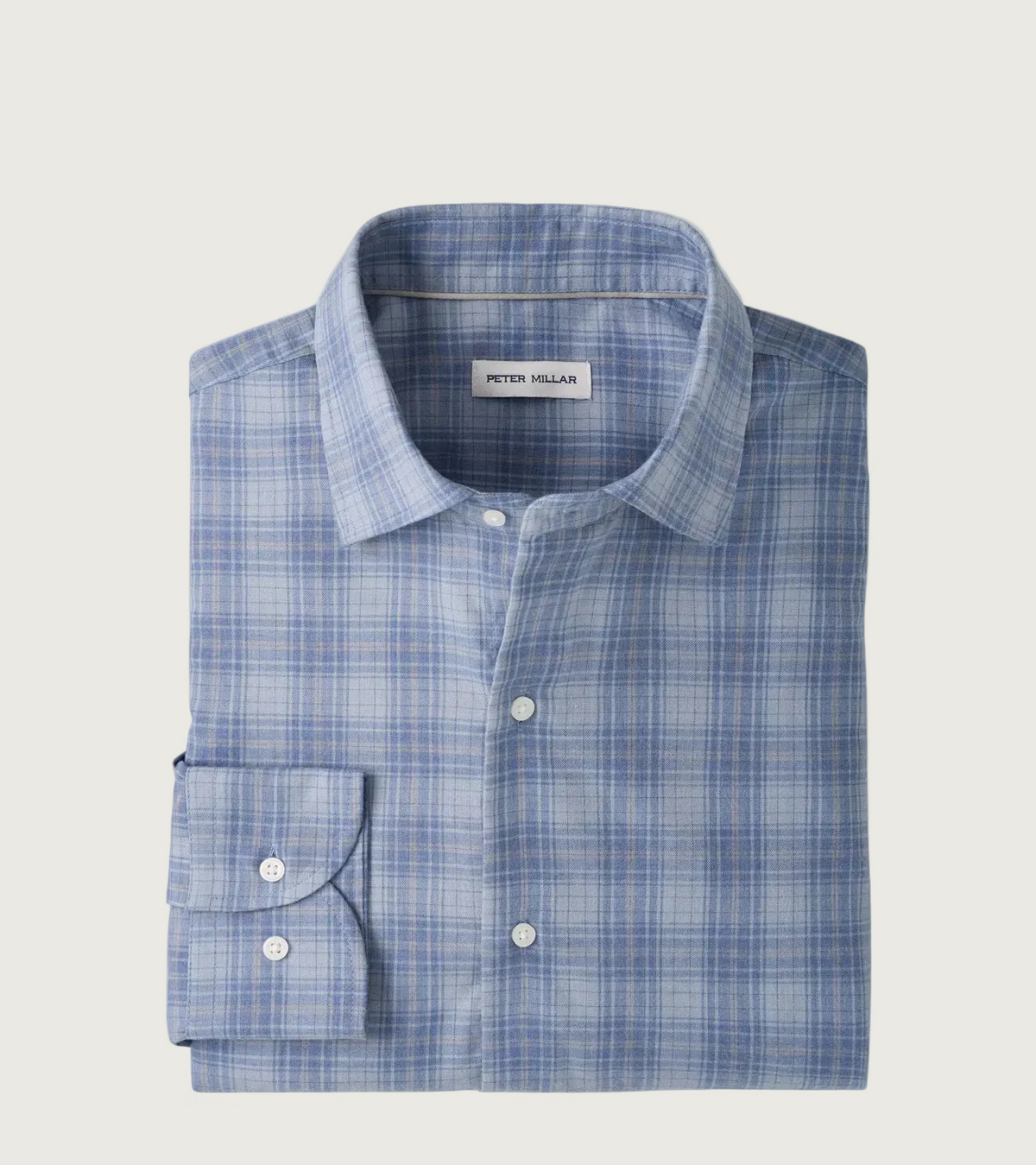 A folded Peter Millar dress shirt in a light blue and white plaid pattern, featuring a classic collar, button-down front, and a single-button cuff, displayed on a clean white background.