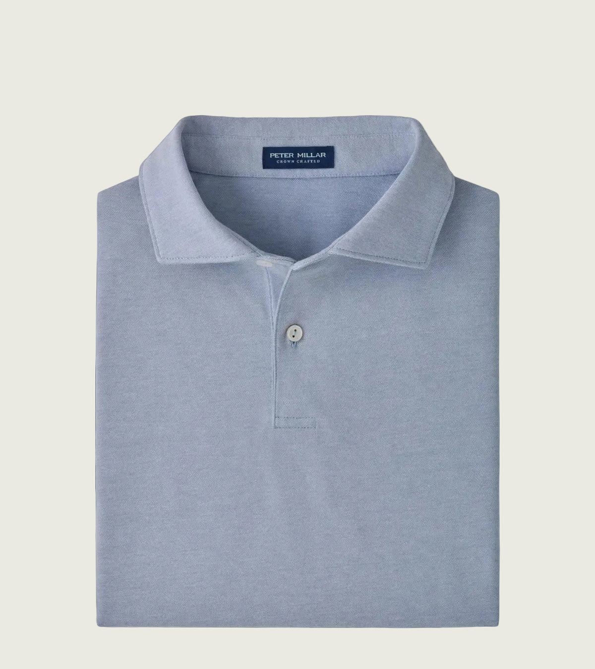 A folded light blue polo shirt by Peter Millar, neatly arranged on a clean white background.