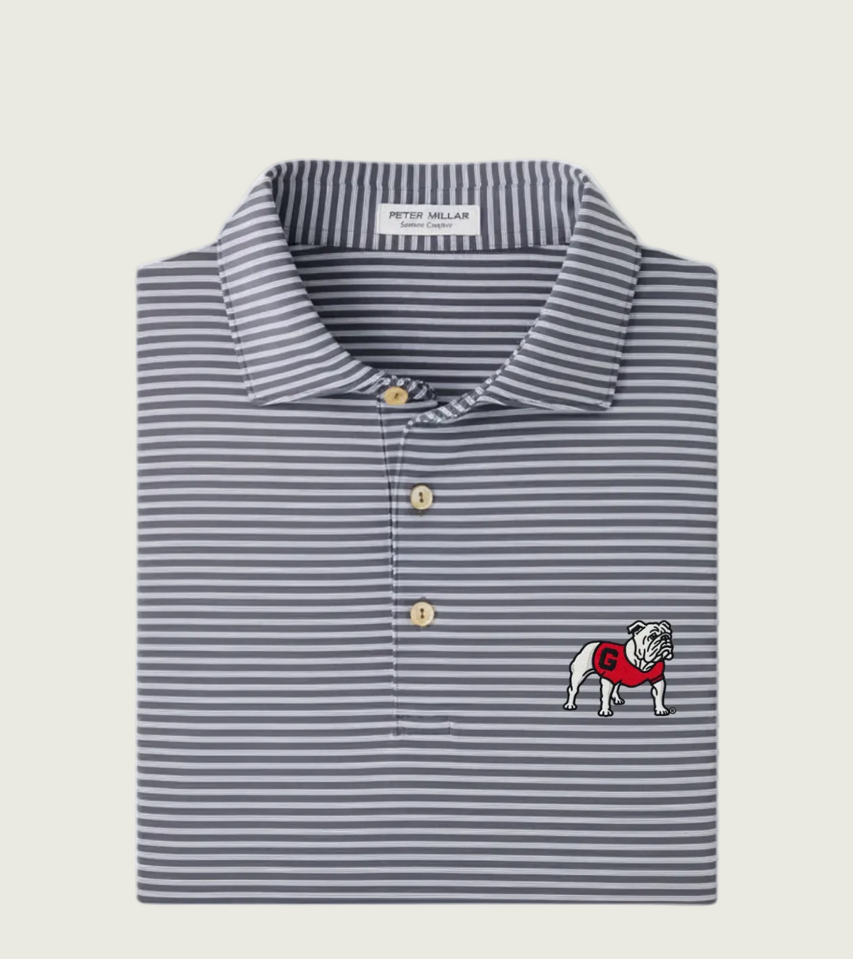 A folded Peter Millar Blue Heron polo shirt featuring navy and gray horizontal stripes, with a white embroidered bulldog logo wearing a red sweater on the chest.