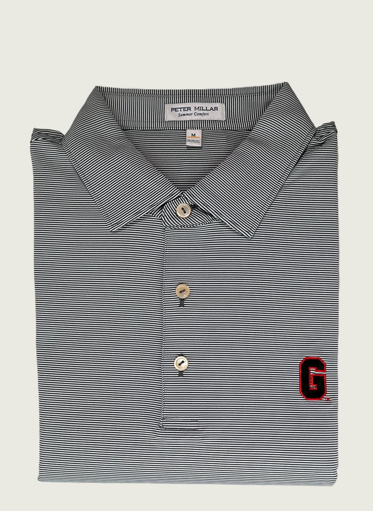 A gray Peter Millar polo shirt with a red 'G' logo on the chest, displayed on a mannequin.