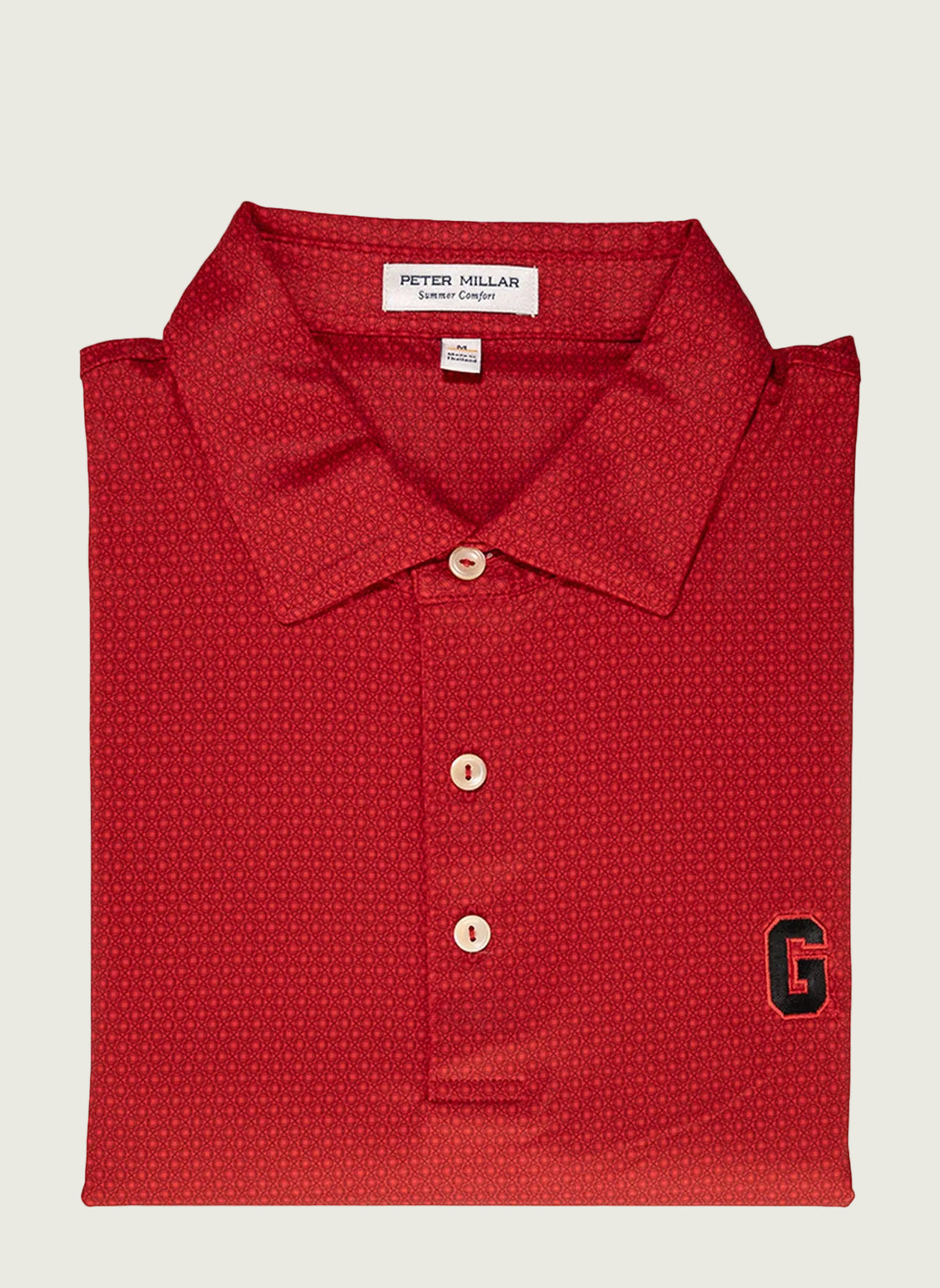 A red Peter Millar polo shirt with a checkered pattern, Sean self collar, and the brand's logo on the chest.