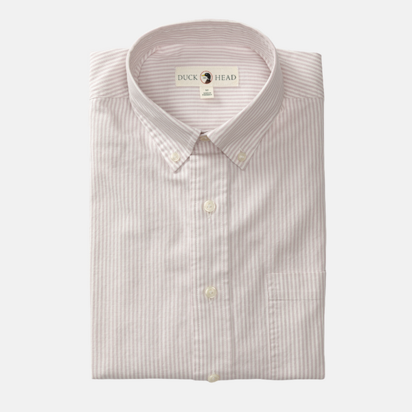 Folded Faded Peri Cotton Oxford Collins Shirt. Shirt has has light pink and white vertical stripes and off-white buttons.