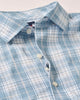 Close-up of a blue and white plaid shirt with buttons.