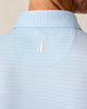 Light blue striped shirt with Johnnie-O logo at the nape of the neck on a neutral background