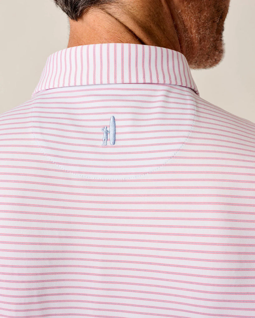 Close-up of a person wearing a pink and white striped polo shirt with a small blue Johnnie-O logo on the nape of the neck.