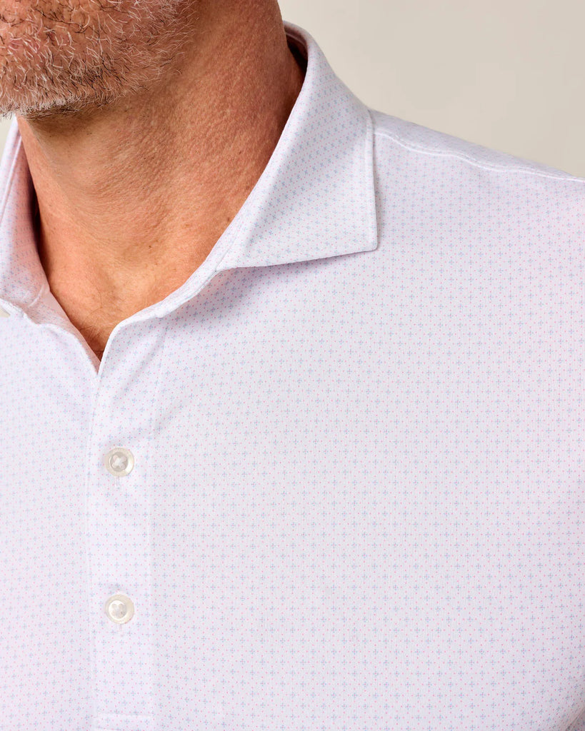 Close-up of a white patterned shirt with a collar and buttons on a neutral background