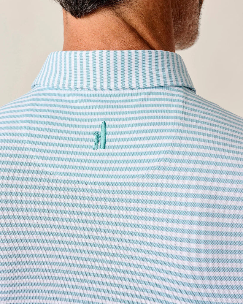 Close-up of a person wearing a light blue and white striped polo shirt with Johnnie-O logo on the nape of the neck.