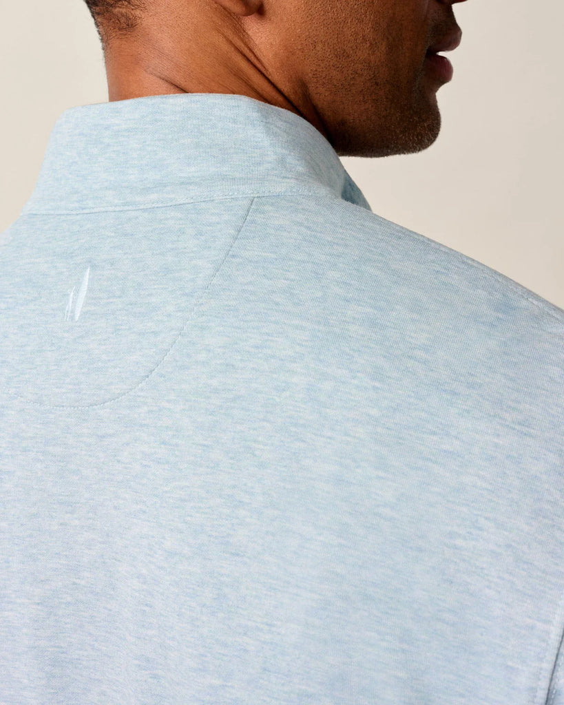 Light blue pullover worn by a person on a beige background