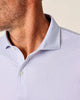 Close-up of a light purple patterned polo shirt with a collar and buttons.