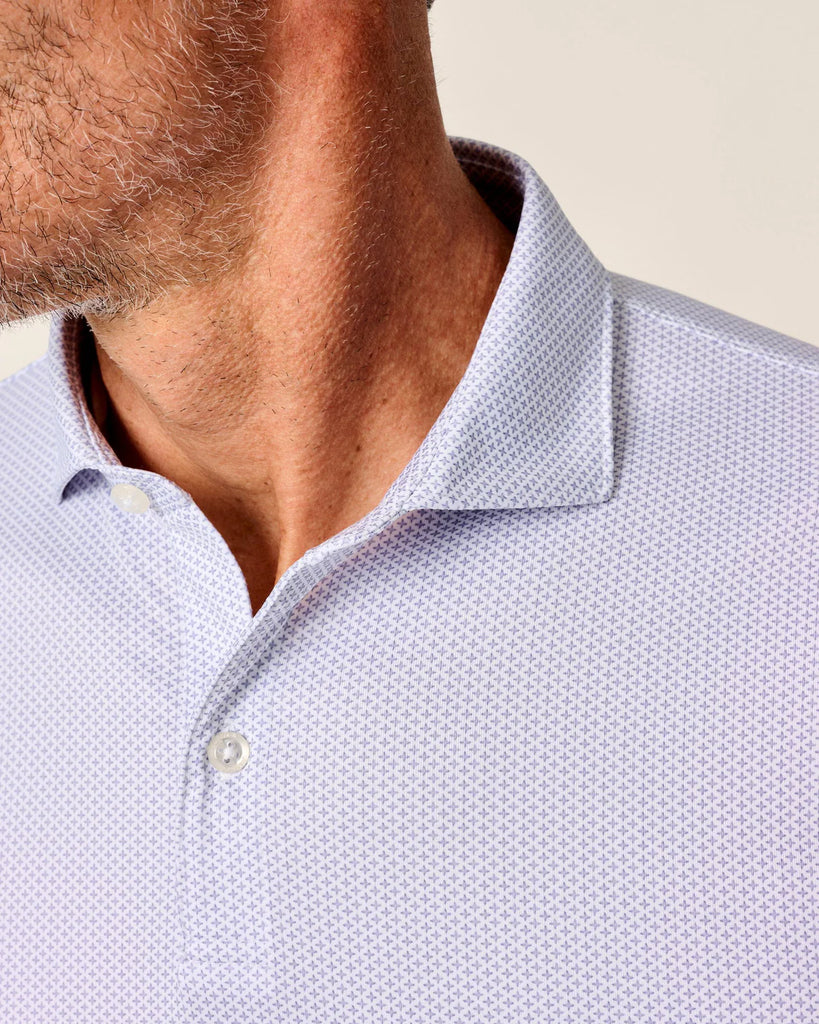 Close-up of a light purple patterned polo shirt with a collar and buttons.