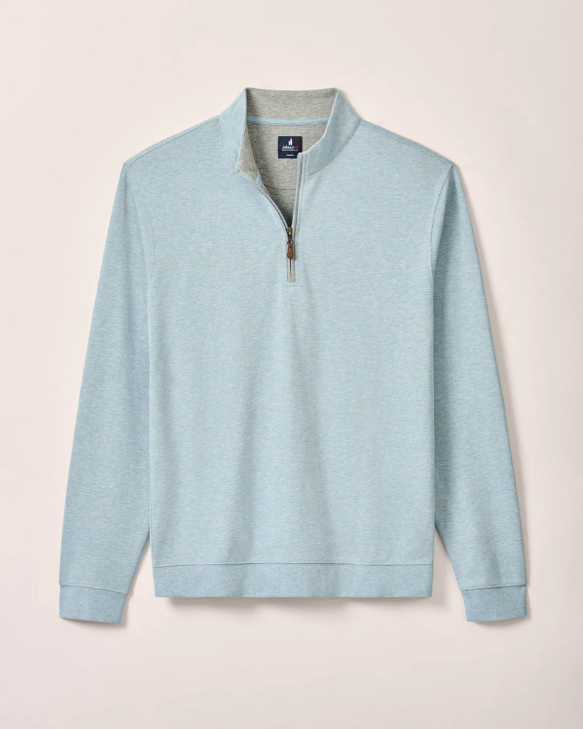 Light blue long-sleeve pullover with a quarter zip on a beige background