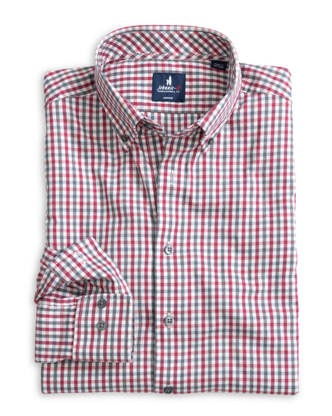 Folded red and gray checkered shirt on a white background