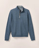 Blue quarter-zip pullover on a beige background