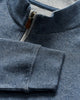 Close-up of a blue pullover with a zipper detail.